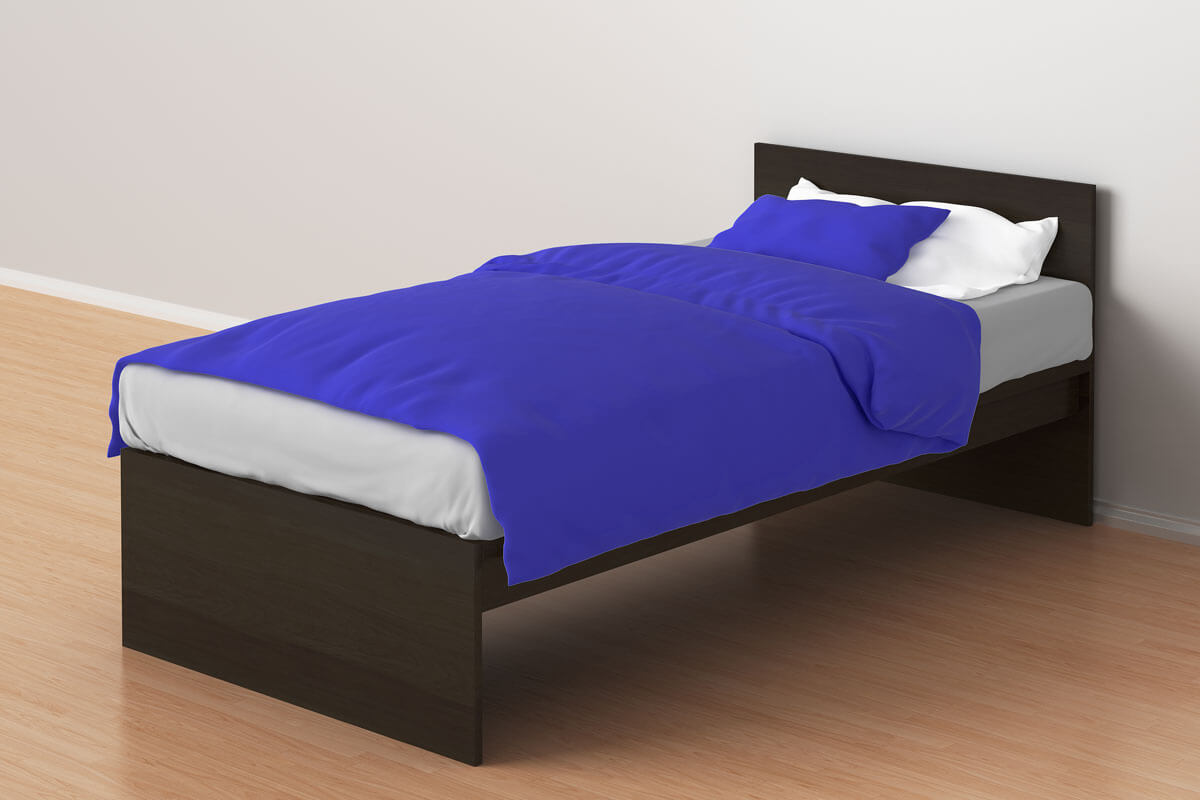 gemachtes einzelbett an einer wand